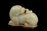 A WHITE JADE CARVED MYTHICAL LION