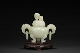 A CARVED CELADON JADE TRIPOD CENSER