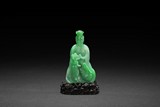 A RARE CARVED NATURAL JADEITE GUANYIN FIGURE WITH GIA CERTIFICATE