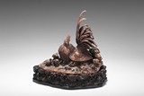 A CARVED RHINOCEROS HORN FIGURAL GROUP 'ROOSTER AND CHICKS'
