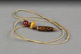 A RARE TIBETAN THREE-EYE DZI BEAD, HAN DYNASTY