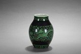 A GREEN GLAZED BLACK GROUND 'DRAGONS' JAR