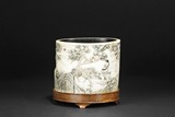 AN IVORY CARVED BRUSH POT WITH STAND
