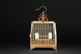 AN IVORY AND WOOD CARVED BIRD CAGE