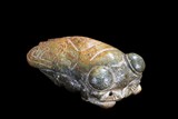 A GREEN AND RUSSET JADE CARVED CICADA ORNAMENT