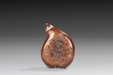 A CARVED CINNABAR SNUFF BOTTLE