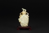A CARVED JADEITE TWO RING-HANDLED SNUFF BOTTLE