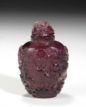 A CARVED PURPLE GLASS SNUFF BOTTLE