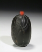 A CARVED HARDSTONE SNUFF BOTTLE