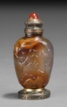 A BRONZE ENCASED CARVED RUSSET AGATE SNUFF BOTTLE WITH BIXI STOPPER