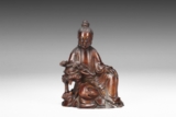 A CARVED HUANGHUALI FIGURE OF GUANYIN