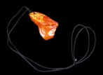 A CARVED EGG YOLK AMBER PENDANT