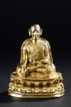A TIBETAN GILT-BRONZE FIGURE OF SEATED LAMA