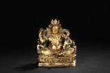 A TIBETAN GILT-BRONZE FIGURE OF YELLOW JAMBHALA