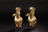 AN UNUSUAL PAIR OF GILT-METAL MODELS OF PHOENIX