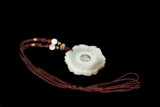 A FLORIFORM JADE PENDANT
