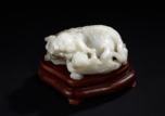 A WHITE JADE CARVING OF TWO LIONS