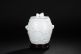 A WHITE GLAZED TWO-HANDLED 'PLUM BLOSSOM' JAR AND COVER