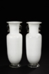 A PAIR OF WHITE AND CLEAR GLASS ROULEAU BOTTLES