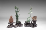 A SET OF TWO CARVED SPINACH JADE 'PLANT' AND 'GRASSHOPPER' DECORATIONS
