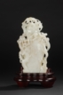 A CARVED WHITE JADE 'MONKEYS AND PEACH' VASE