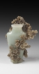 AN ELABORATELY CARVED JADE VASE