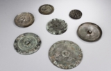 A GROUP OF SEVEN ARCHAIC BRONZE MIRRORS