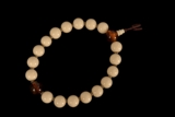 A STRAND OF IVORY AND AMBER BEADS