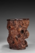 A LARGE NATURALISTIC IRONWOOD ROOT BRUSH POT