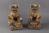 A PAIR OF GLAZED CERAMIC LION FIGURES