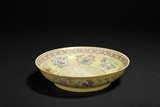 A LARGE YELLOW-GROUND FAMILLE ROSE DISH