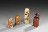 A SET OF FOUR SOAPSTONE SEALS