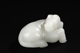 A WHITE JADE CARVED RECUMBENT HORSE