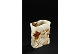 A WHITE AND RUSSET JADE CARVED BRUSHPOT