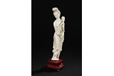 AN IVORY FIGURE OF A BEAUTY WITH FAN