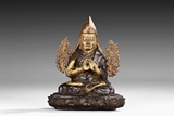 A WOODEN PARCEL-GILT DALAI LAMA CARVING