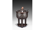 A BRONZE TRIPOD CENSER WITH COVER