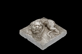 A MARBLE CARVED RECUMBENT LION FIGURE