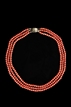 A VINTAGE THREE-STRAND RED CORAL NECKLACE