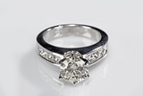 A SOUTH AFRICAN 14K WHITE GOLD DIAMOND RING