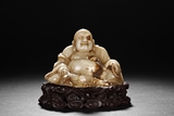 A CARVED SHOUSHAN STONE MAITREYA BUDDHA FIGURE