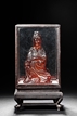 AN AMBER CARVED MODEL OF GUANYIN