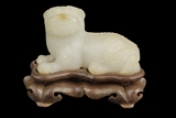 A WHITE JADE CARVED MODEL OF MYTHICAL LION