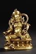 A GILT-BRONZE FIGURE OF YELLOW JAMBHALA