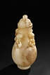 A WHITE AND RUSSET JADE VASE WITH COVER