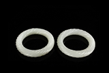 A PAIR OF WHITE JADE ROPE-TWISTED BANGLES