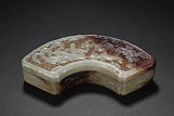 A CELADON AND RUSSET JADE FAN-SHAPED BOX