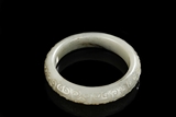 A WHITE JADE CIRCULAR 'CLOUD' BANGLE