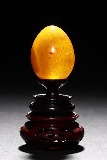 AN EGG-SHAPED GOLDEN AMBER