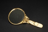 A SILVER-GILT IVORY HAND MIRROR